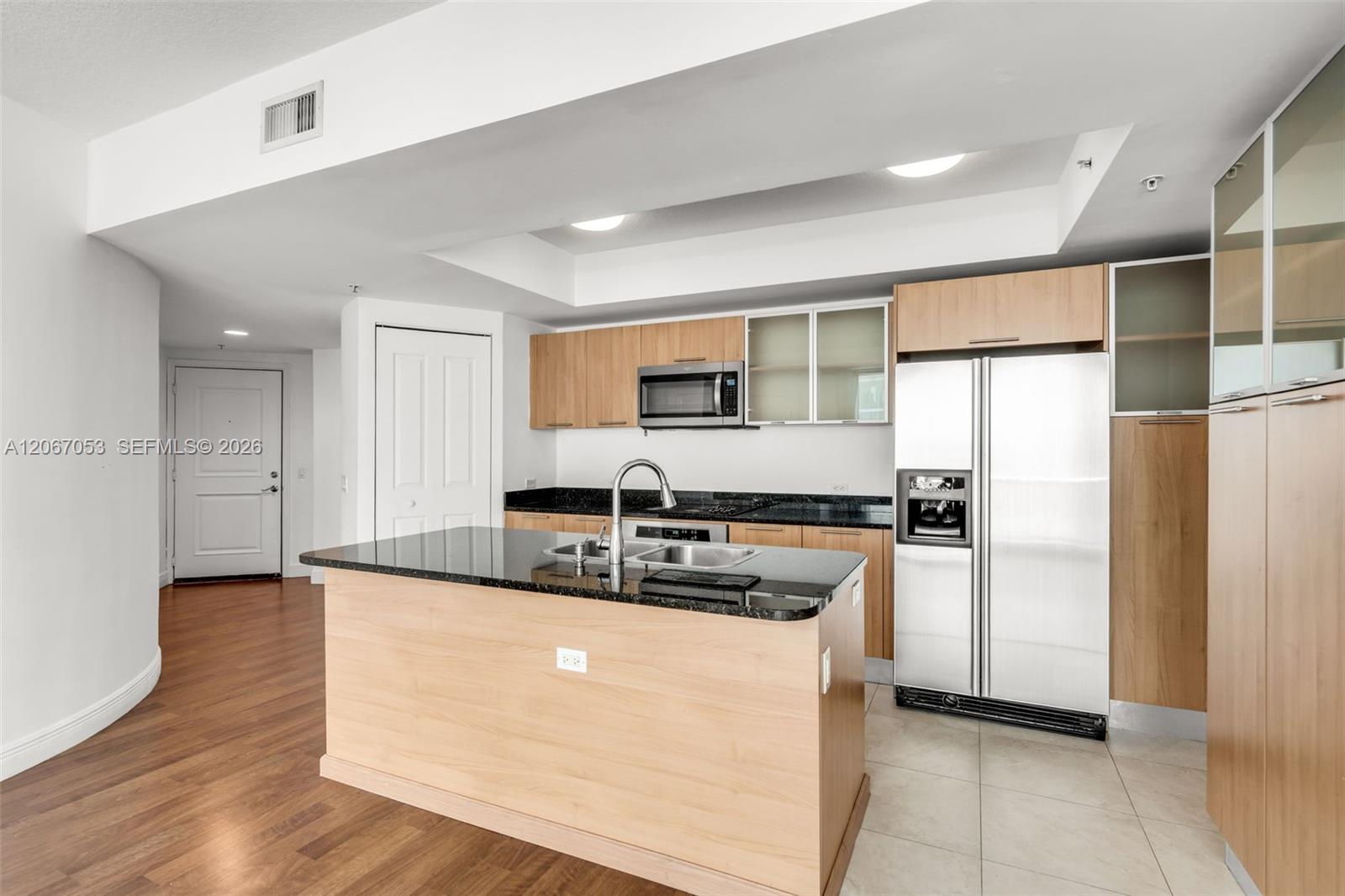 Open kitchen with granite counters and breakfast island
