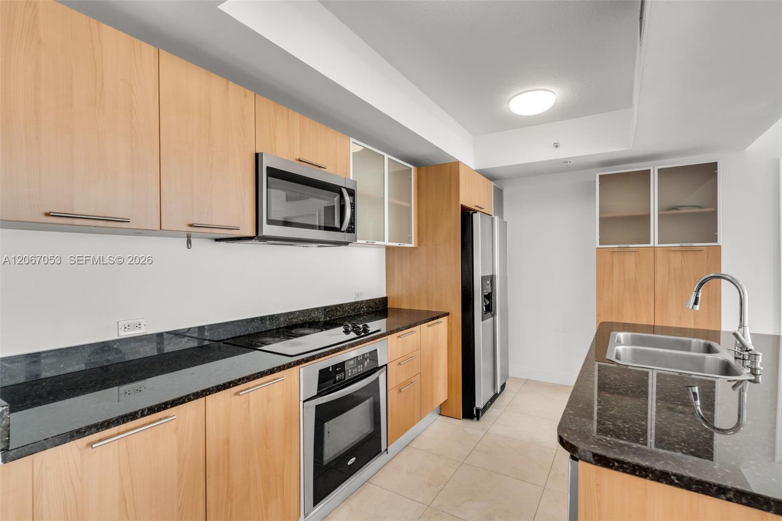 Kitchen with stainless appliances and wood cabinetry