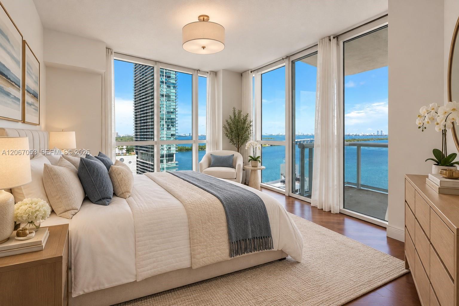 Primary bedroom, virtually staged, with corner windows over the bay