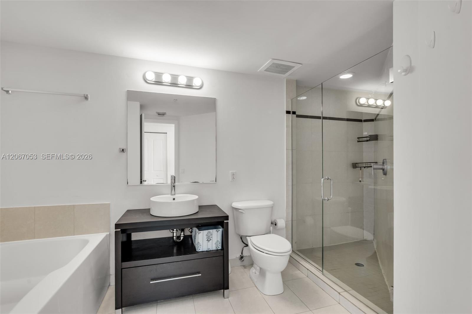 Primary bathroom with glass shower and vessel sink