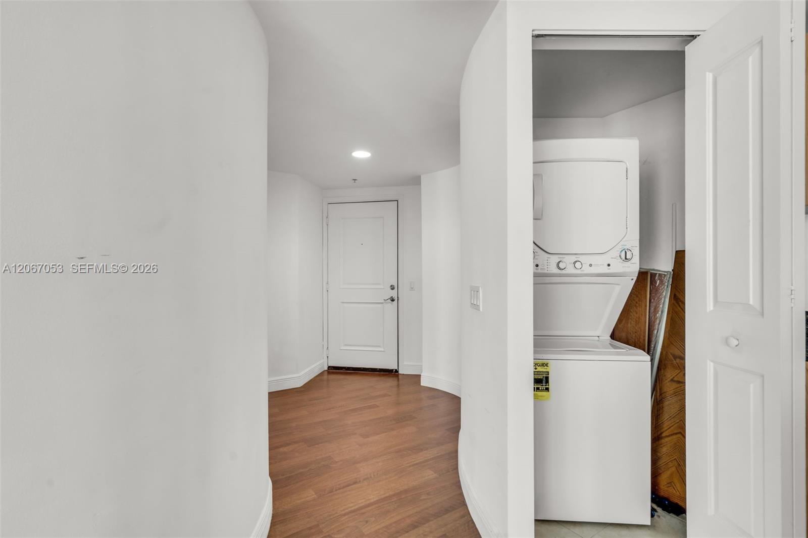 Laundry closet with stacked washer and dryer