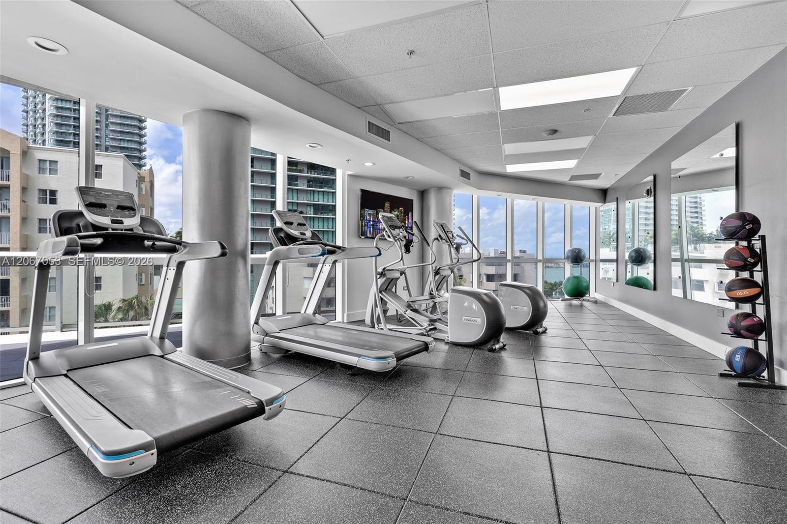 Fitness center with cardio equipment and bay views